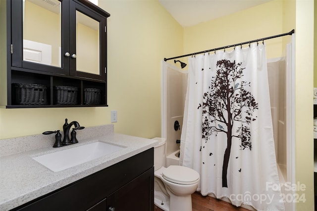 full bathroom featuring vanity, shower / tub combo, hardwood / wood-style flooring, and toilet