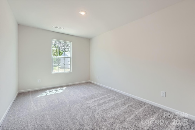 carpeted spare room with baseboards, recessed lighting, and visible vents