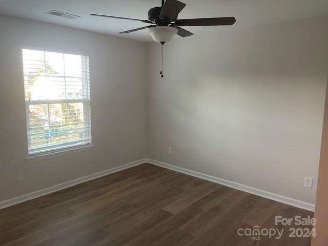 spare room with ceiling fan and dark hardwood / wood-style floors