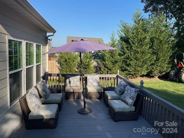 wooden terrace with an outdoor living space