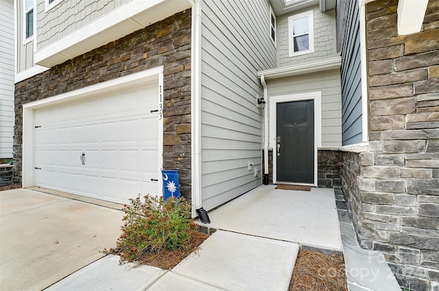 view of exterior entry featuring a garage