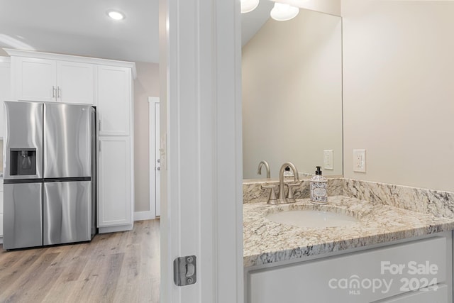 bathroom featuring vanity and hardwood / wood-style flooring