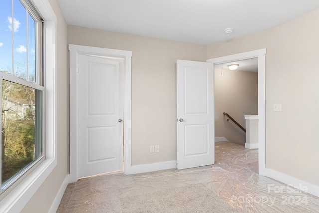 unfurnished bedroom with light carpet