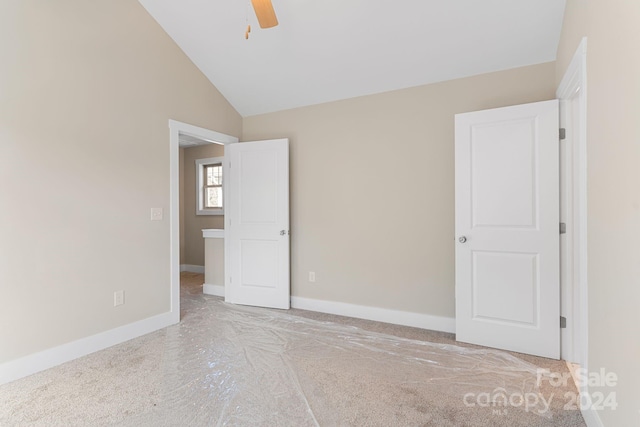 unfurnished bedroom with ceiling fan and lofted ceiling