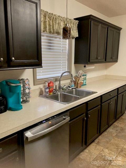 kitchen with sink, stainless steel dishwasher, and dark brown cabinetry