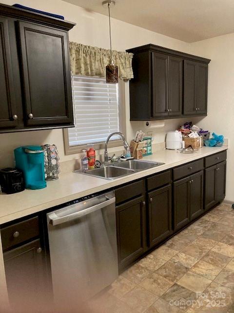 kitchen featuring dark brown cabinetry, sink, decorative light fixtures, and dishwasher