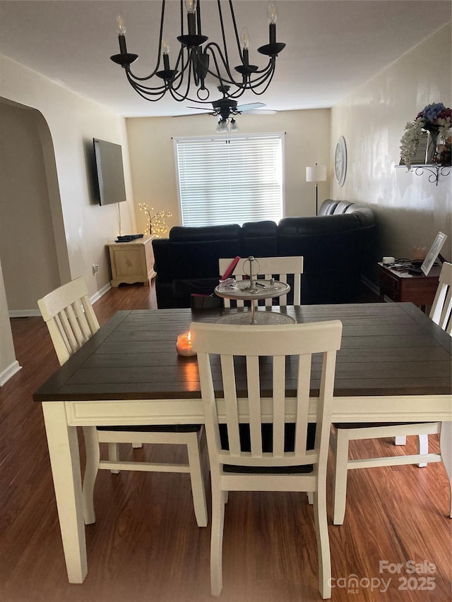 dining area featuring dark hardwood / wood-style flooring and a chandelier