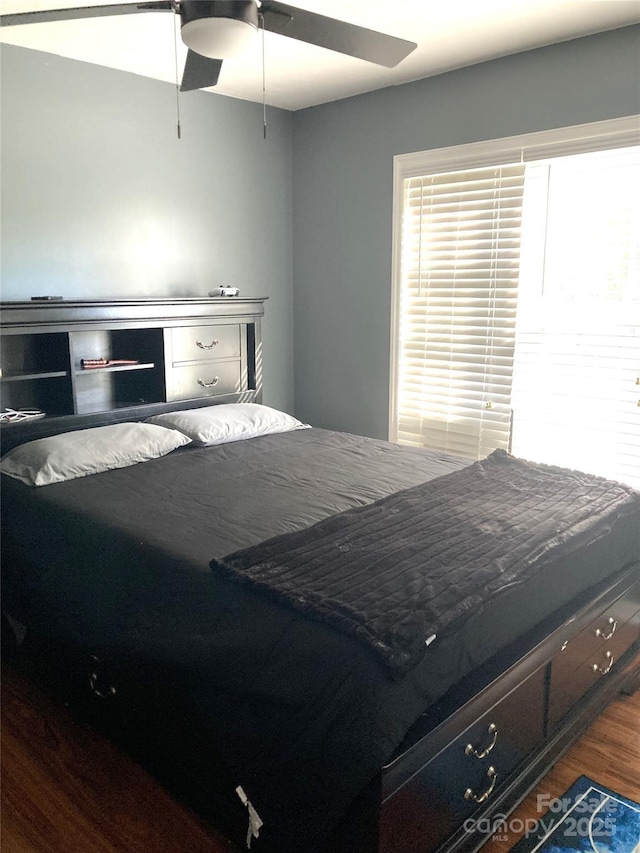 bedroom with ceiling fan and wood-type flooring