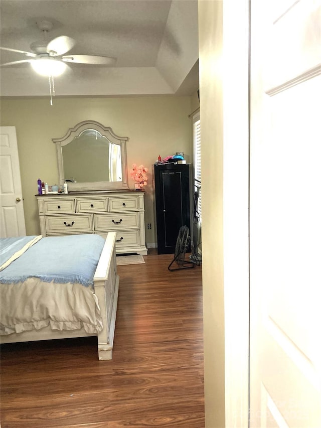 bedroom with ceiling fan and dark hardwood / wood-style floors