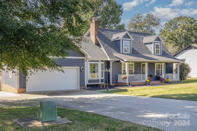 cape cod-style house featuring a porch, a garage, and a front lawn