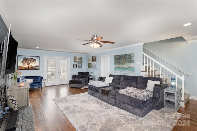 living room with ceiling fan, french doors, dark hardwood / wood-style floors, crown molding, and a fireplace