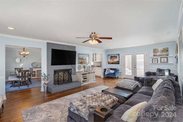 living room with crown molding, a fireplace, and dark wood-type flooring