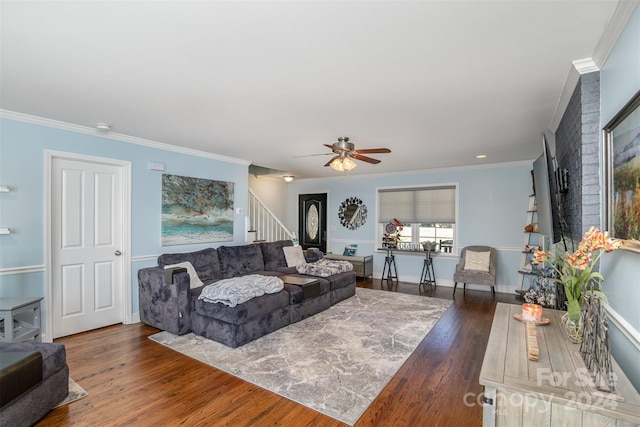 living room with ceiling fan, dark wood-type flooring, and ornamental molding