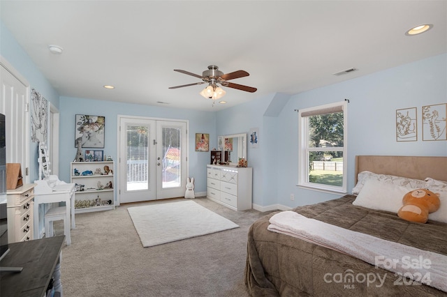 carpeted bedroom with access to outside, ceiling fan, and french doors