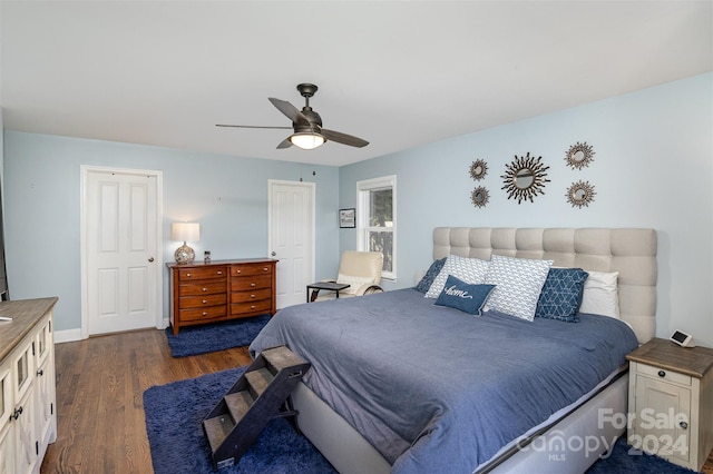 bedroom featuring ceiling fan and dark hardwood / wood-style floors