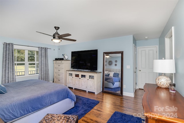 bedroom with ceiling fan and dark hardwood / wood-style flooring