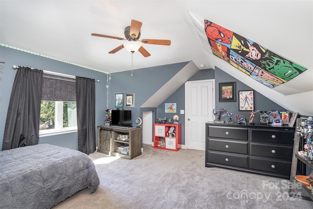 carpeted bedroom featuring ceiling fan and vaulted ceiling