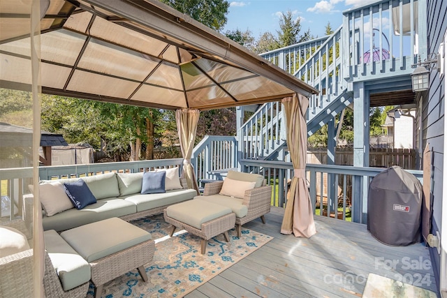 deck with a gazebo and an outdoor living space