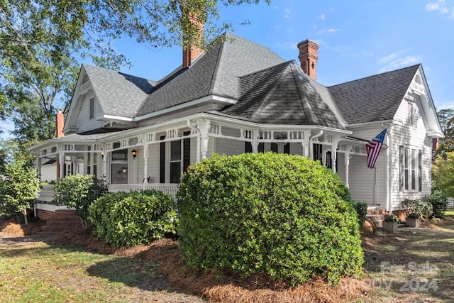 rear view of house featuring a porch