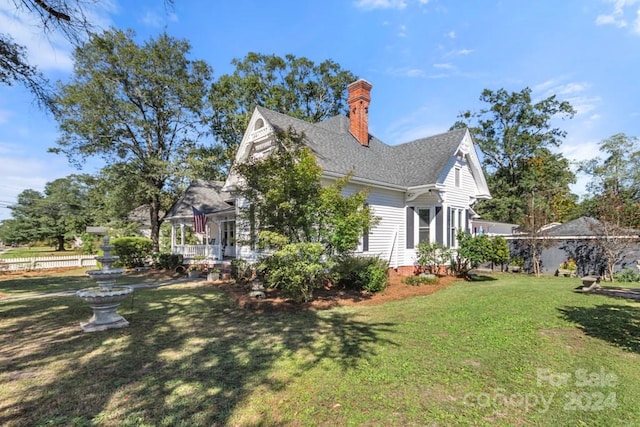 view of side of home with a lawn