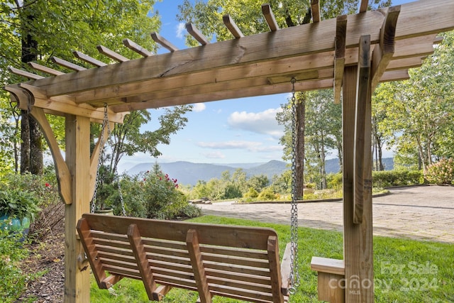 exterior space featuring a mountain view and a pergola