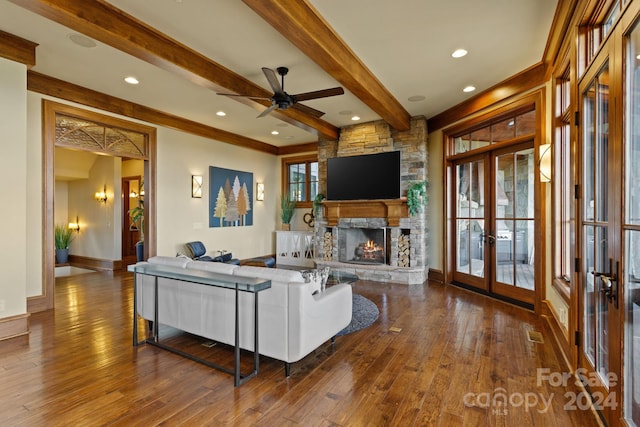 living room featuring french doors, beamed ceiling, a fireplace, and dark wood-type flooring