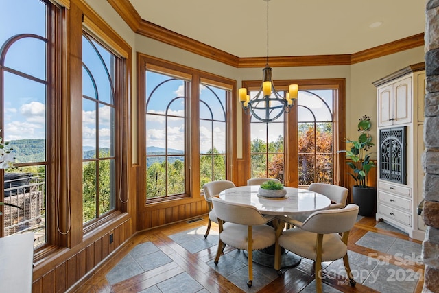 sunroom / solarium featuring a notable chandelier and a wealth of natural light