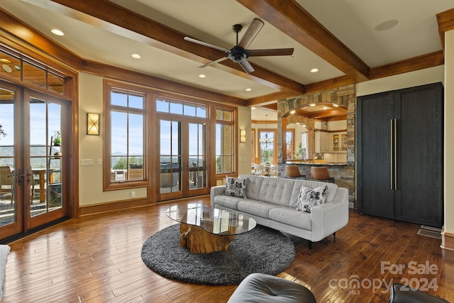 living room featuring french doors, dark hardwood / wood-style floors, beamed ceiling, and a wealth of natural light