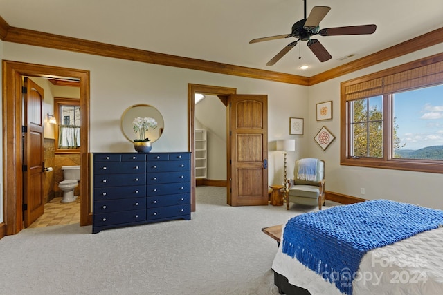 bedroom with ceiling fan, light carpet, ensuite bath, and ornamental molding