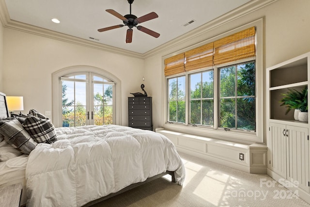 bedroom featuring ceiling fan, crown molding, carpet flooring, and multiple windows