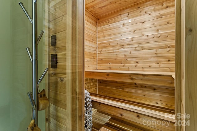 view of sauna with wood ceiling and wooden walls