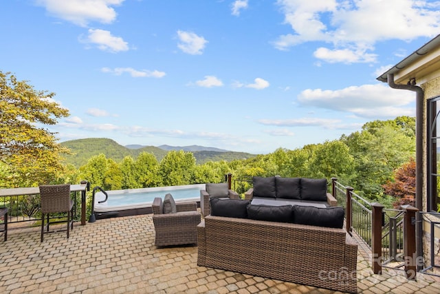 view of patio with a mountain view and a swimming pool