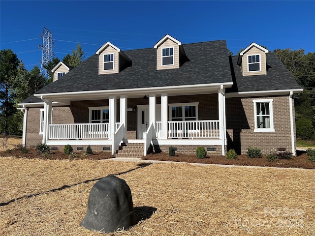 cape cod home featuring a porch