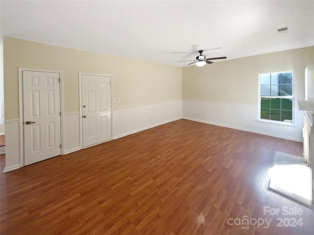 spare room with ceiling fan and dark hardwood / wood-style floors