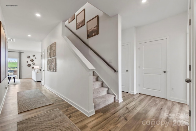 staircase with wood-type flooring