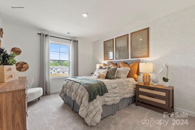 bedroom featuring light carpet