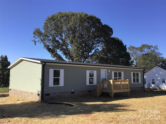 rear view of house with a wooden deck