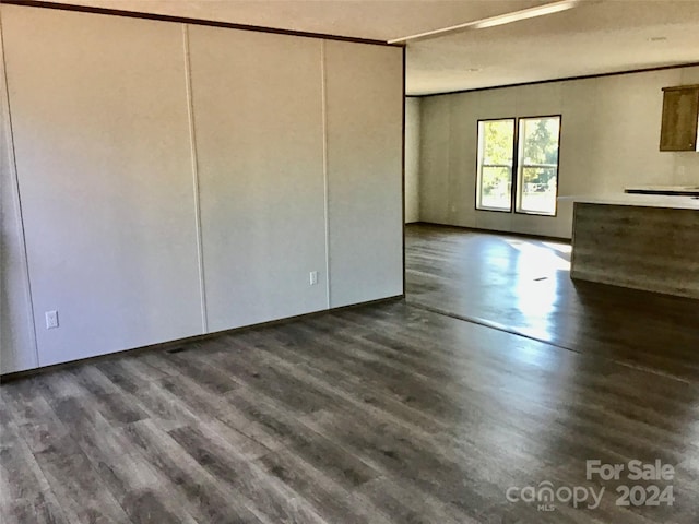 empty room with dark hardwood / wood-style flooring