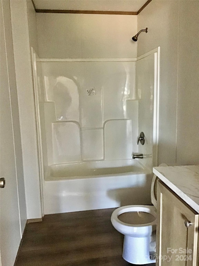 full bathroom with toilet, wood-type flooring, shower / washtub combination, ornamental molding, and vanity