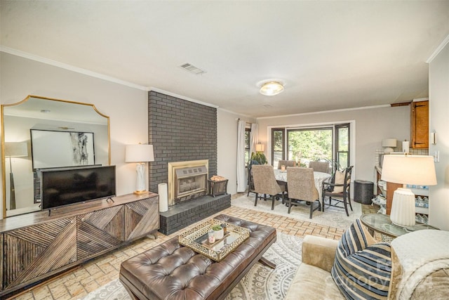 living room with ornamental molding and a brick fireplace