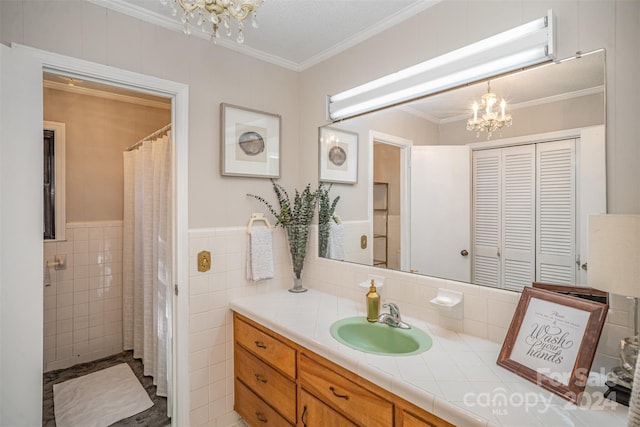 bathroom featuring vanity, crown molding, a chandelier, and tile walls