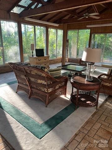 sunroom featuring ceiling fan, a healthy amount of sunlight, and vaulted ceiling