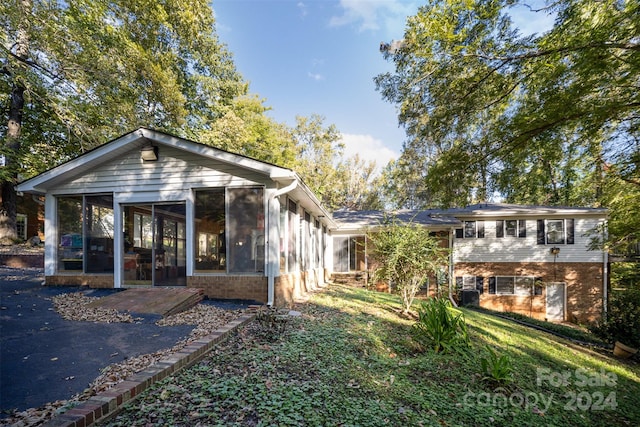 back of property with a sunroom