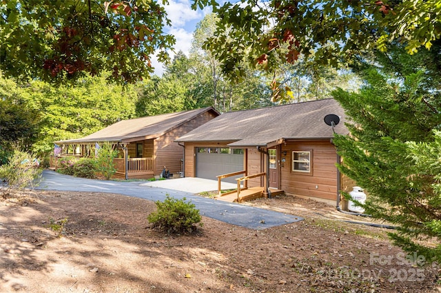 single story home with covered porch and a garage