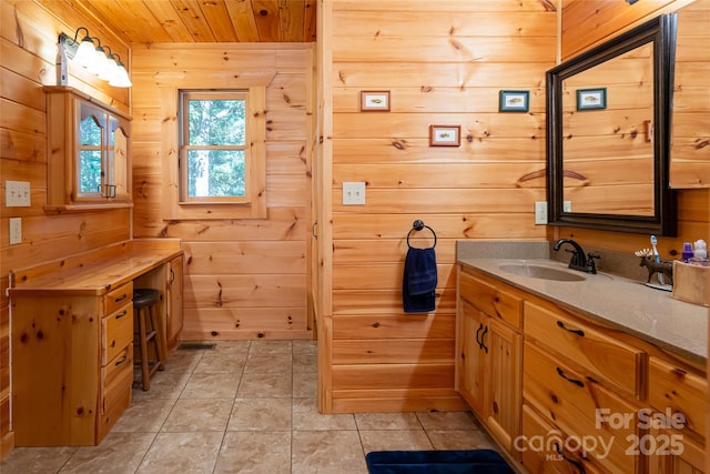 bathroom featuring tile patterned flooring, vanity, wooden ceiling, and wood walls