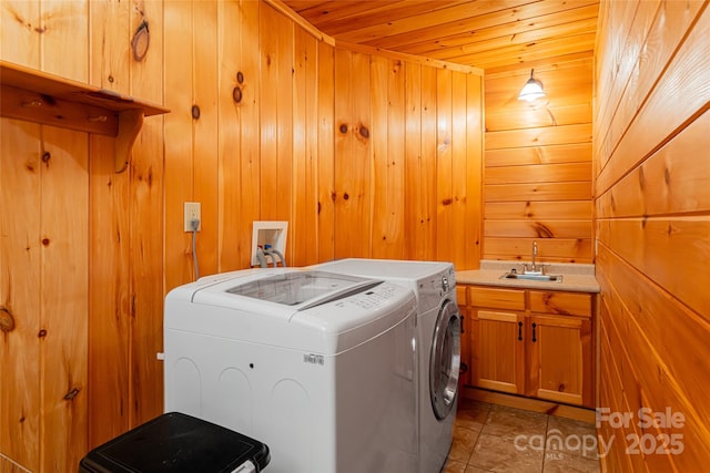 laundry area featuring cabinets, wooden ceiling, sink, wooden walls, and light tile patterned flooring