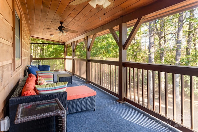 sunroom / solarium featuring ceiling fan, a healthy amount of sunlight, wood ceiling, and lofted ceiling