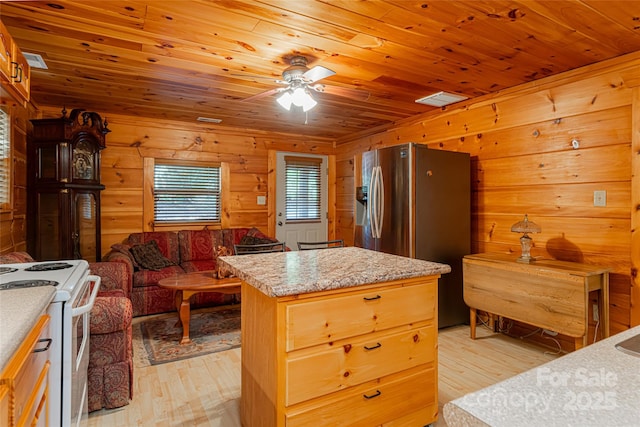 kitchen featuring wooden ceiling, electric stove, stainless steel fridge, a kitchen island, and light hardwood / wood-style floors