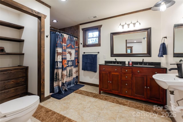 bathroom with toilet, ornamental molding, sink, and walk in shower