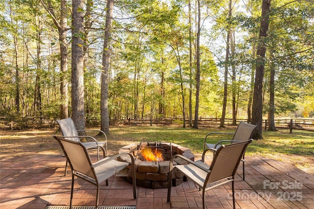 view of patio / terrace featuring an outdoor fire pit